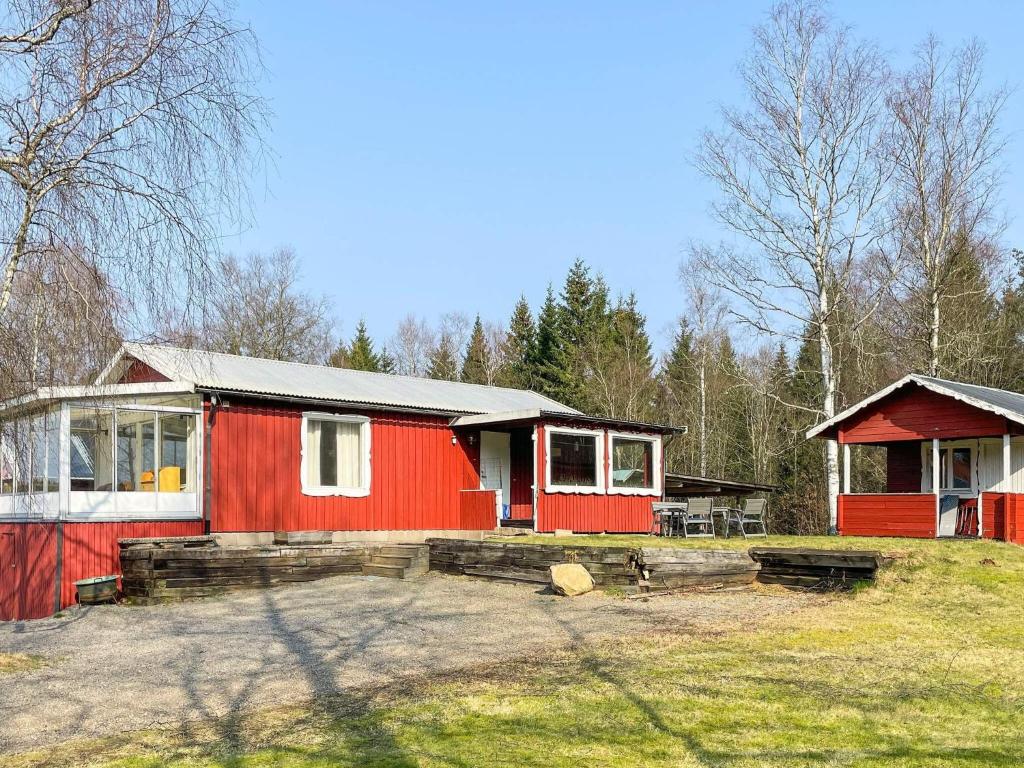 a red and white house in the middle of a field at Countryside retreat for 4 guests in Skånes Fagerhult