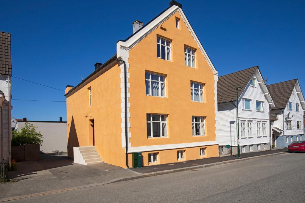 a large orange building on the side of a street at Central Guest House - Bedroom with Private Bathroom in Stavanger