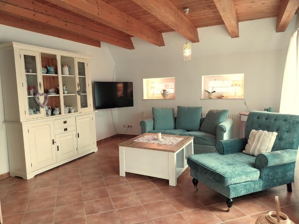 a living room with a couch and a table at Ferienhaus Dea in Krummhörn