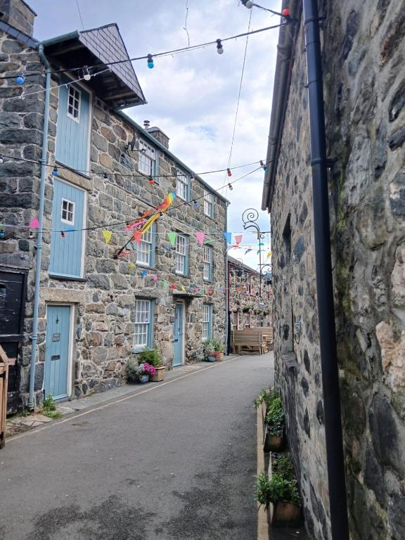 an alley in an old stone building with flags at Forden House in Dolgellau