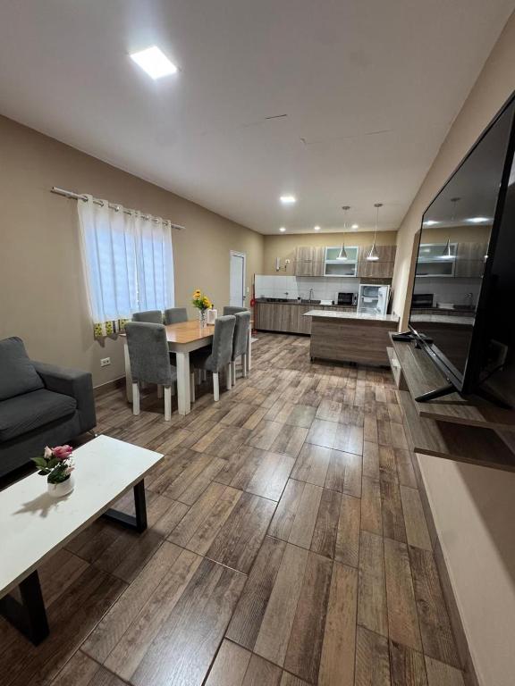 a living room with a couch and a table at Apart Hotel BRIANA in Puerto Iguazú