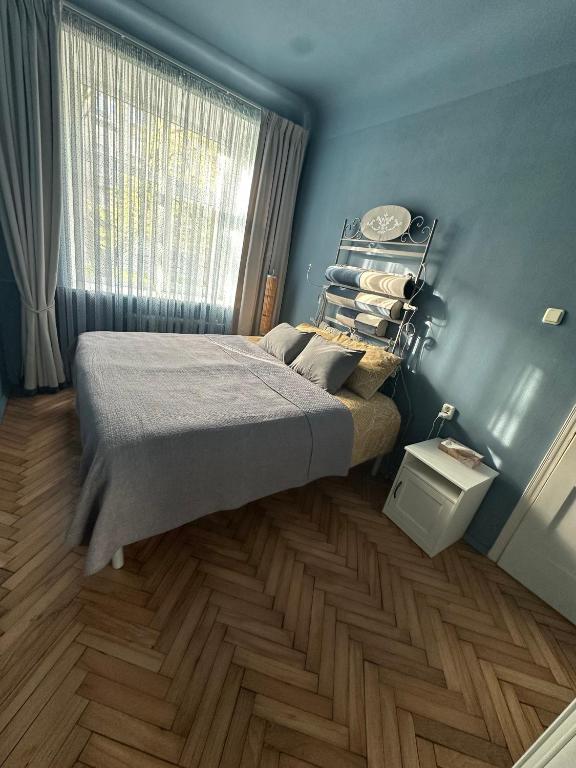 a bedroom with a bed and a window at Cozy Apartment- Self Check- In in Riga