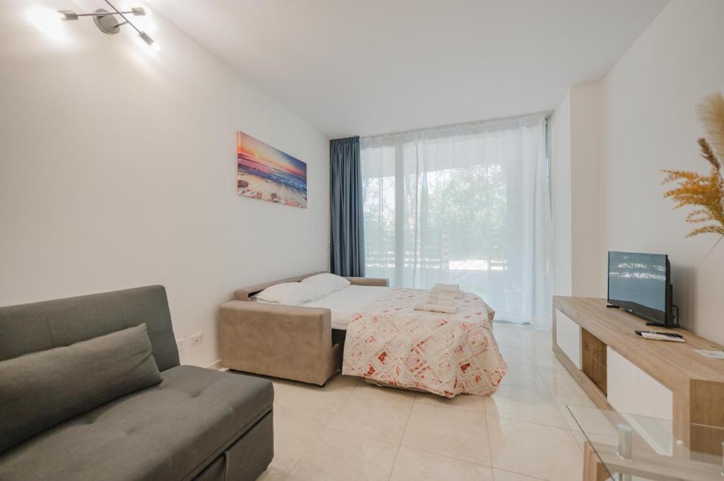 TV a/nebo společenská místnost v ubytování Vacanze Residence Mimose