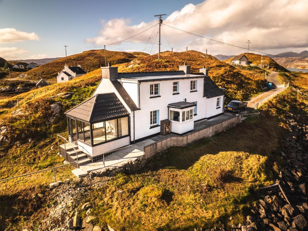 a white house on the side of a hill at Sea Room, Scalpay in Scalpay