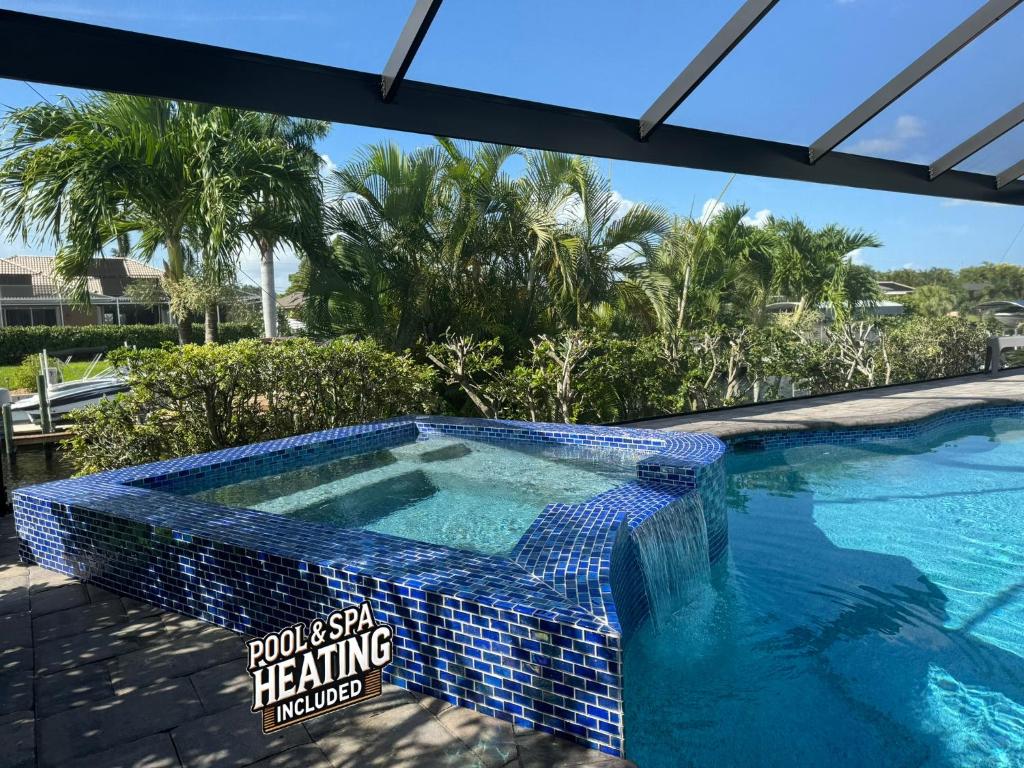a swimming pool with a blue tile around it at Fun In The Sun: Canal Access in Cape Coral