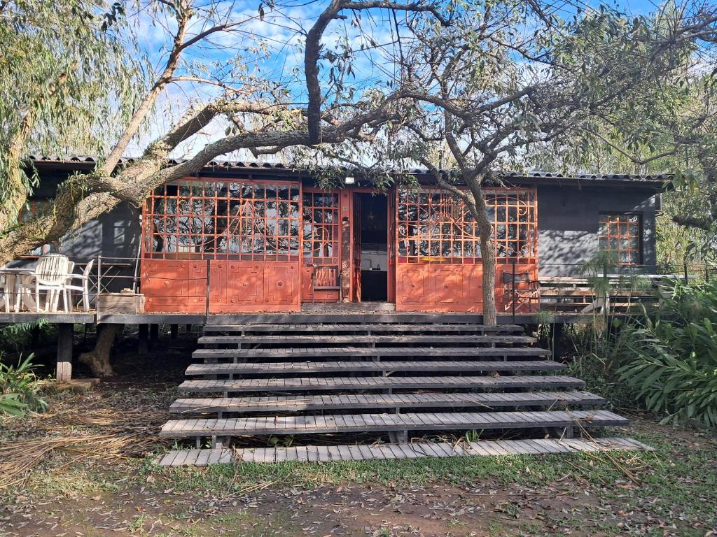 a house with stairs leading up to a building at Full moon house in Tigre