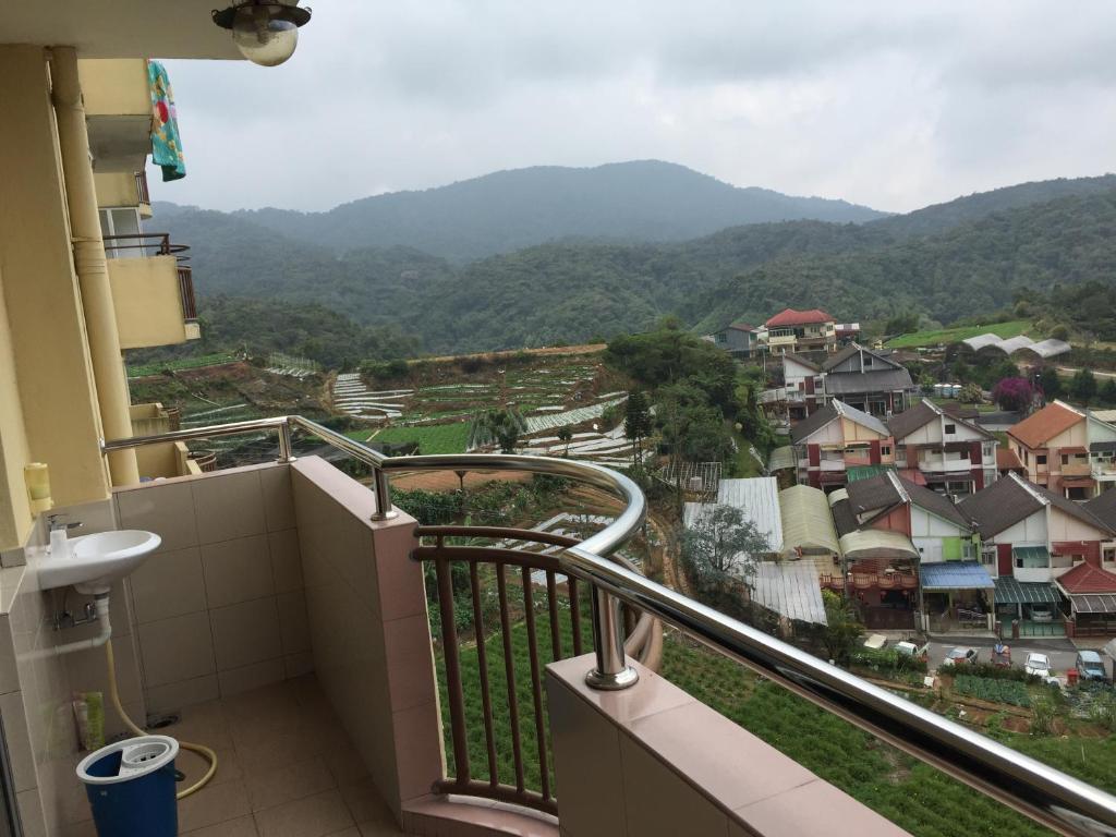a balcony with a view of a town and mountains at Cameron Pasar Malam Apartment @ Crown Imperial Court in Cameron Highlands