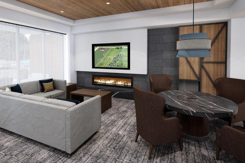 a living room with a couch and a fireplace at Staybridge Suites Toronto Airport East by IHG in Toronto