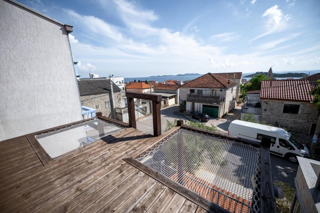 an apartment balcony with a view of a city at Kisas Loft By Pinch in Pakoštane