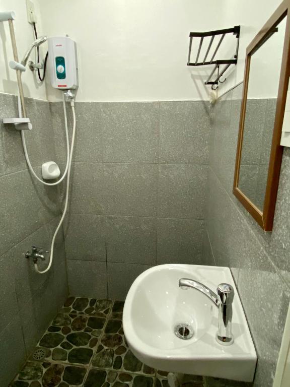 a bathroom with a sink and a shower at Moalboal Panagsama beach TopBudz Hostel in Moalboal