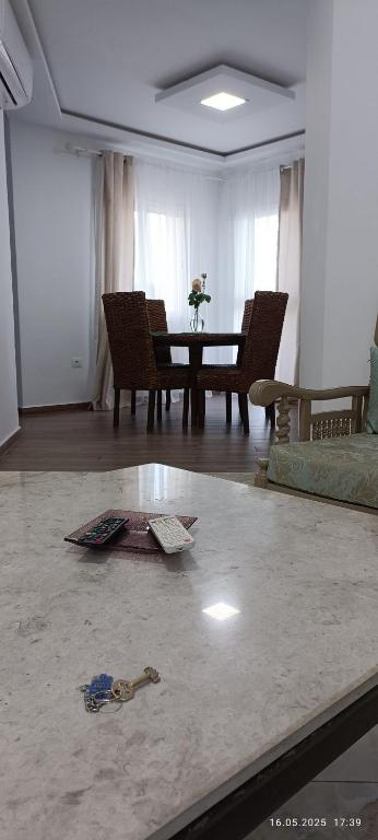 a living room with a table and a pair of keys on the floor at TIM Haute standing appartment S2, center Monastir in Monastir