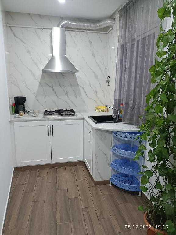 a white kitchen with a sink and a stove at TIM Haute standing appartment S2, center Monastir in Monastir