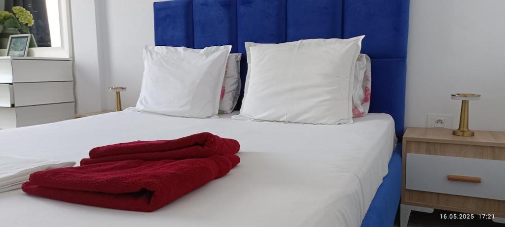 a white bed with red towels on it at TIM Haute standing appartment S2, center Monastir in Monastir
