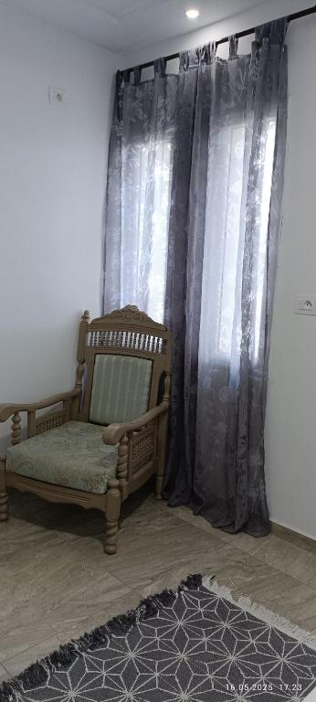 a room with a bed and curtains and a rug at TIM Haute standing appartment S2, center Monastir in Monastir