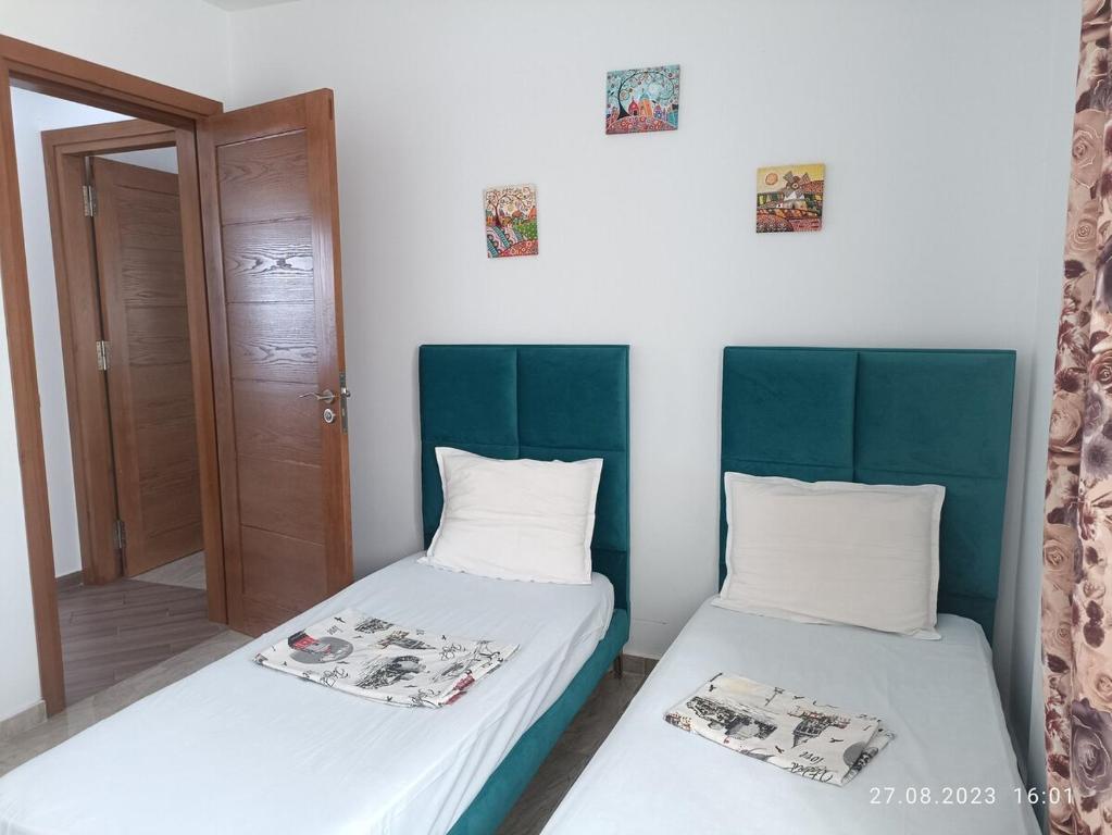 two beds sitting next to each other in a room at TIM Haute standing appartment S2, center Monastir in Monastir