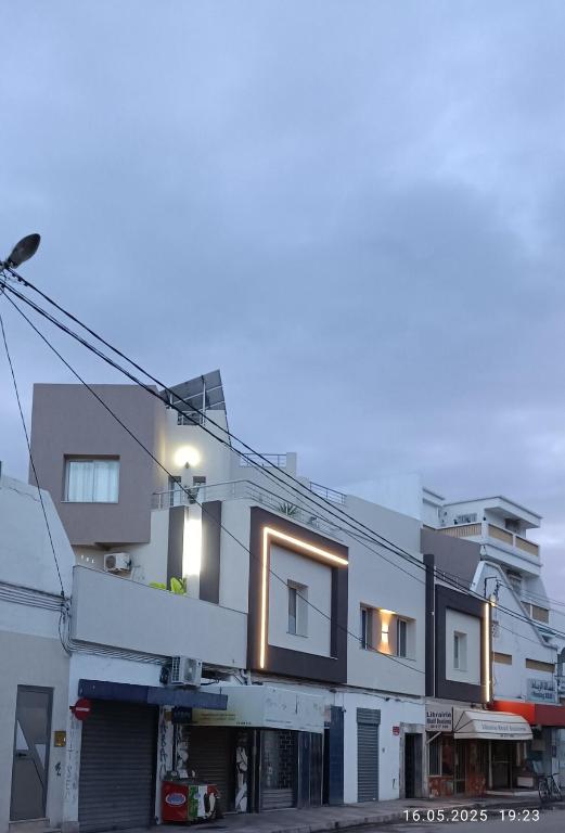 a building with lights on the side of it at TIM Haute standing appartment S2, center Monastir in Monastir