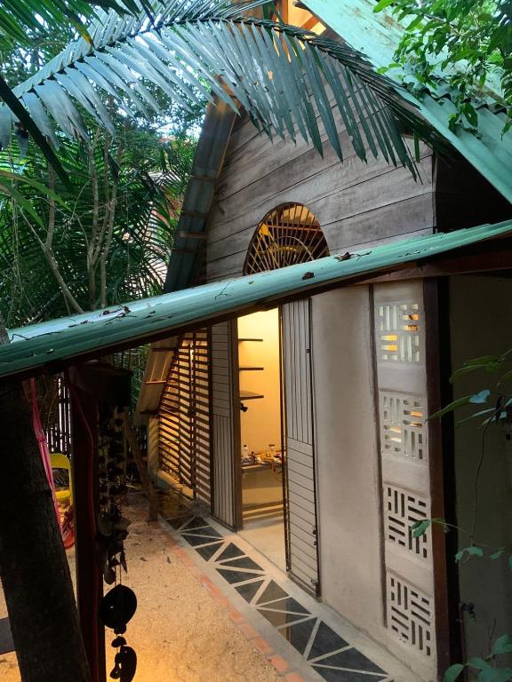 a house with a door and a palm tree at Estudio Embira - Lago Verde in Santarém