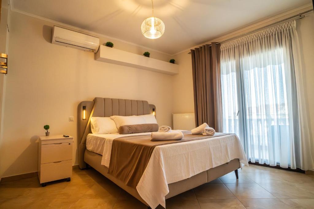 a bedroom with a bed and a large window at Bella Panorama in Alexandroupoli