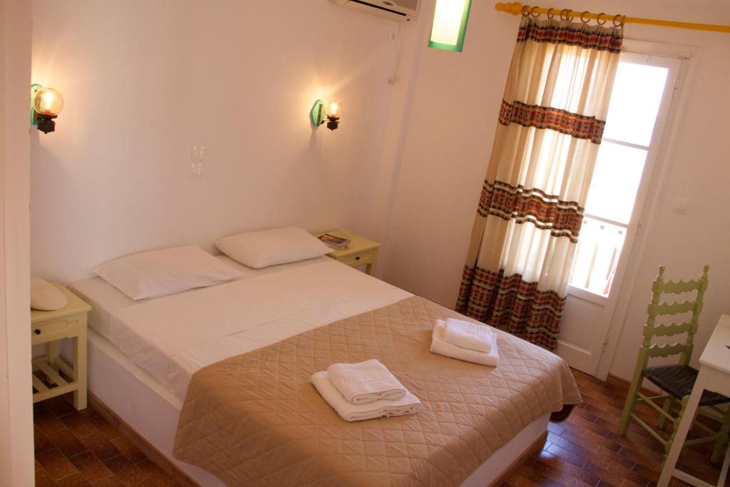 Postel nebo postele na pokoji v ubytování Arokaria Seaside