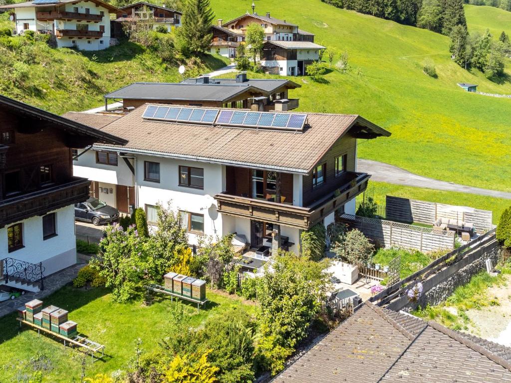 an aerial view of a house with solar panels on its roof at Blumenwiese I und II in Hopfgarten im Brixental