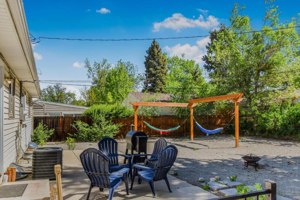 a patio with a table and chairs and a swing at Peaceful retreat in quite neighborhood in Denver