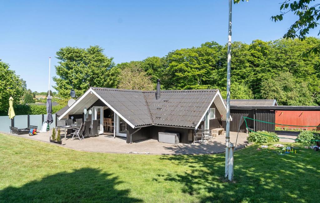 a small house with a roof on a yard at Awesome Home In Hejls With Wifi in Hejls