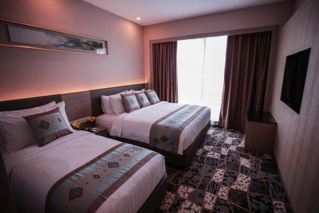 Postel nebo postele na pokoji v ubytování V8 Hotel Johor Bahru