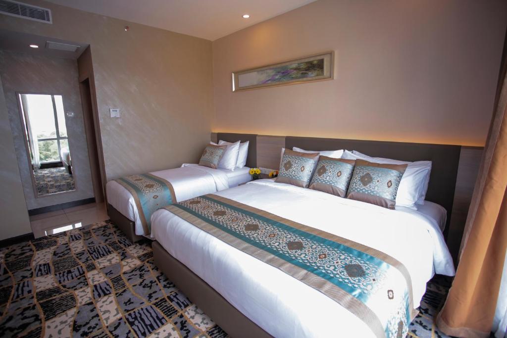 Postel nebo postele na pokoji v ubytování V8 Hotel Johor Bahru