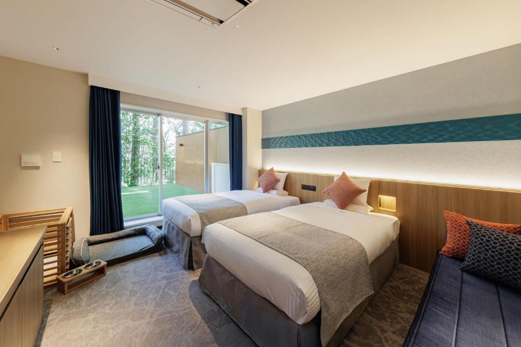 Postel nebo postele na pokoji v ubytování KAMENOI HOTEL Kamogawa