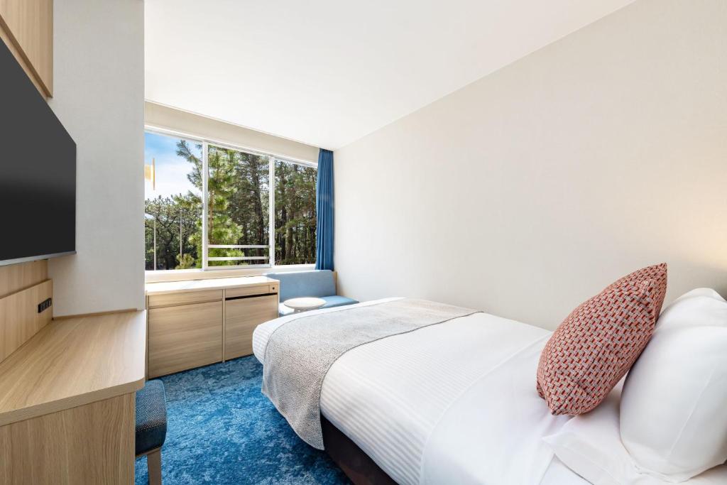 Postel nebo postele na pokoji v ubytování KAMENOI HOTEL Kamogawa