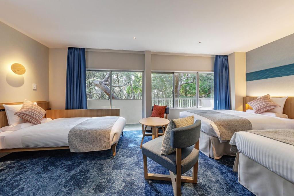 Postel nebo postele na pokoji v ubytování KAMENOI HOTEL Kamogawa