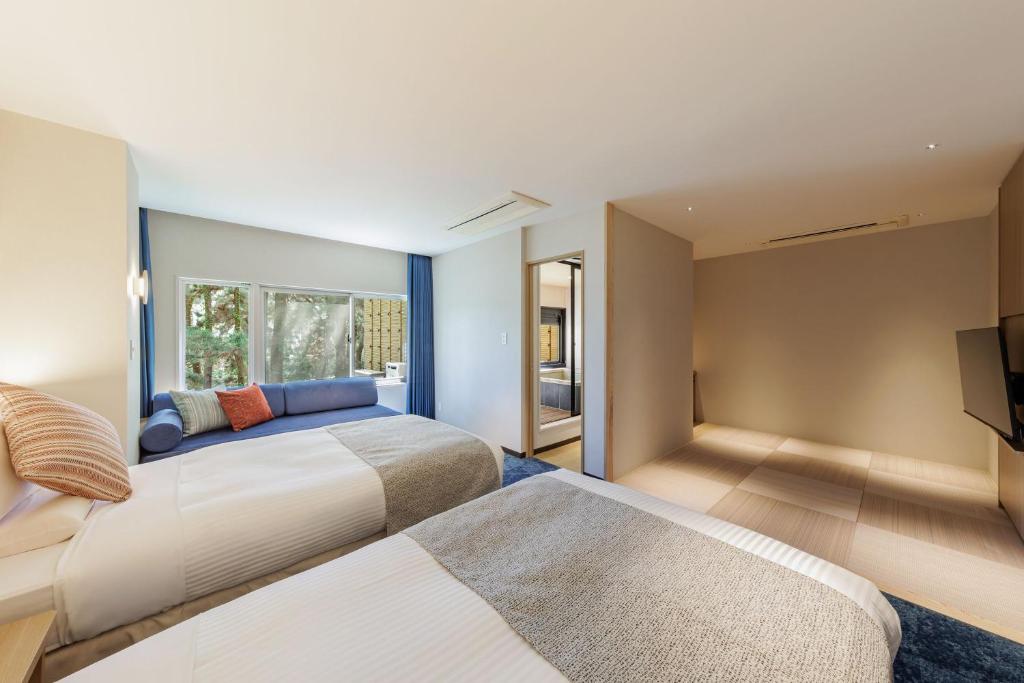 Postel nebo postele na pokoji v ubytování KAMENOI HOTEL Kamogawa