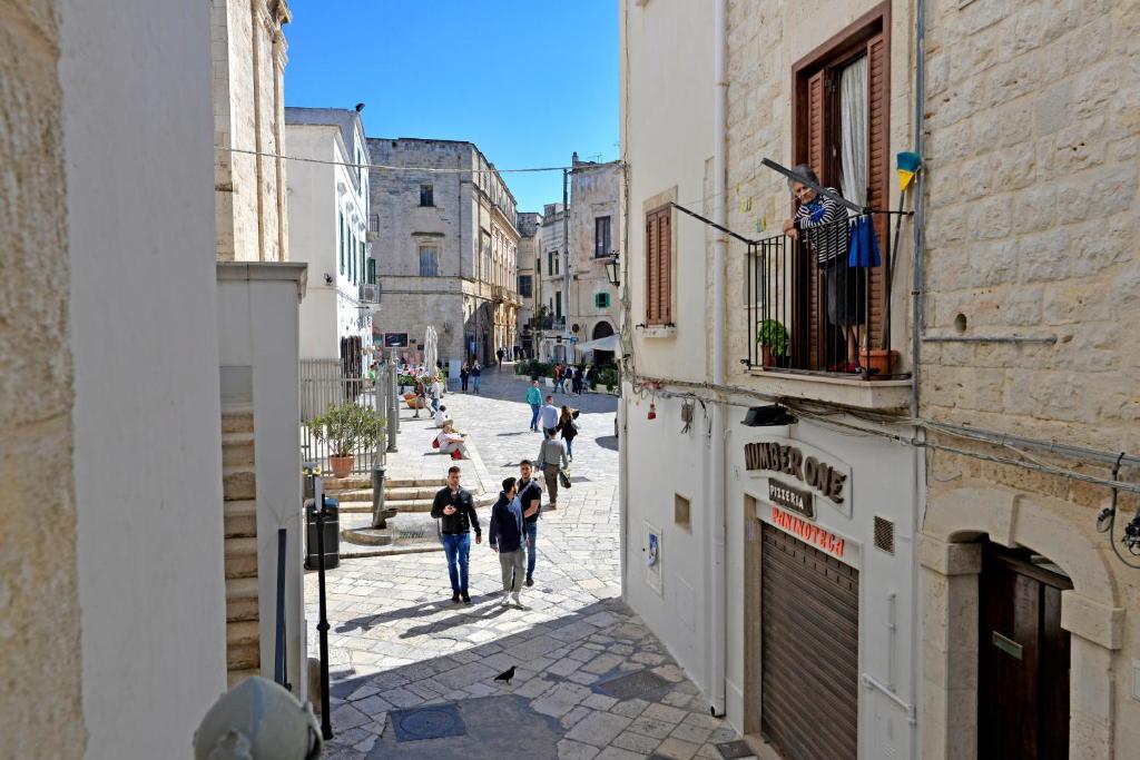 a group of people walking down a street at Casa Aurora in Polignano a Mare