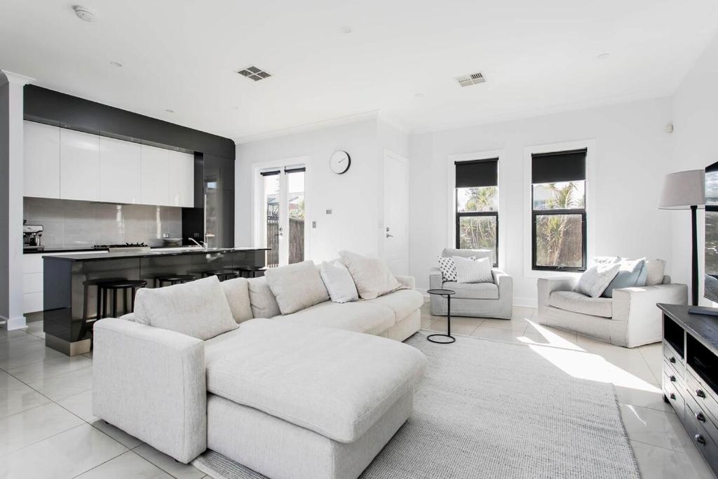 a white living room with a white couch and chairs at Belle Maison - Glenelg, Cafe, Family, Beach in Glenelg