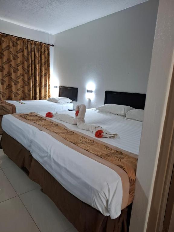 Postel nebo postele na pokoji v ubytování Capricorn International Hotel