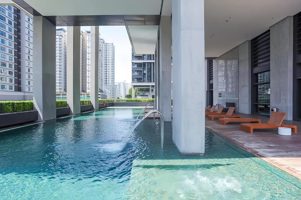 a swimming pool in the middle of a building at Arcoris Mont Kiara in Kuala Lumpur