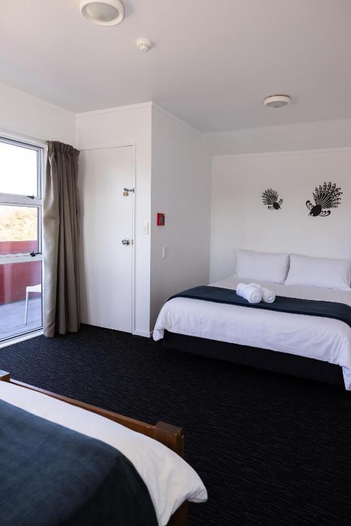 Postel nebo postele na pokoji v ubytování Haka House Taupo