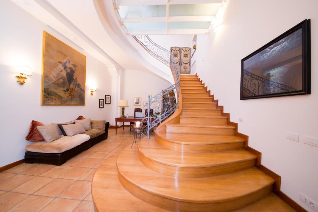 escalera de caracol en una sala de estar con sofá en B&B Maiurè, en Maiori