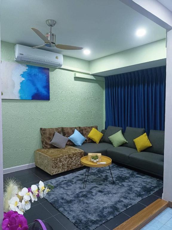 a living room with a couch and a table at 9 Home Phuket in Ban Rangeng