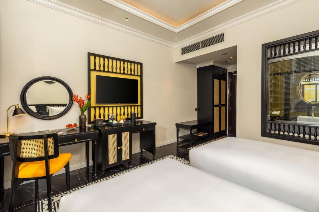 Giường trong phòng chung tại Nesta Hoian Resort & Spa