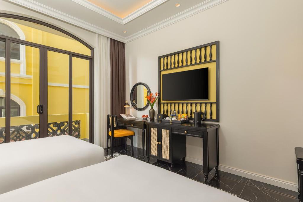 Giường trong phòng chung tại Nesta Hoian Resort & Spa