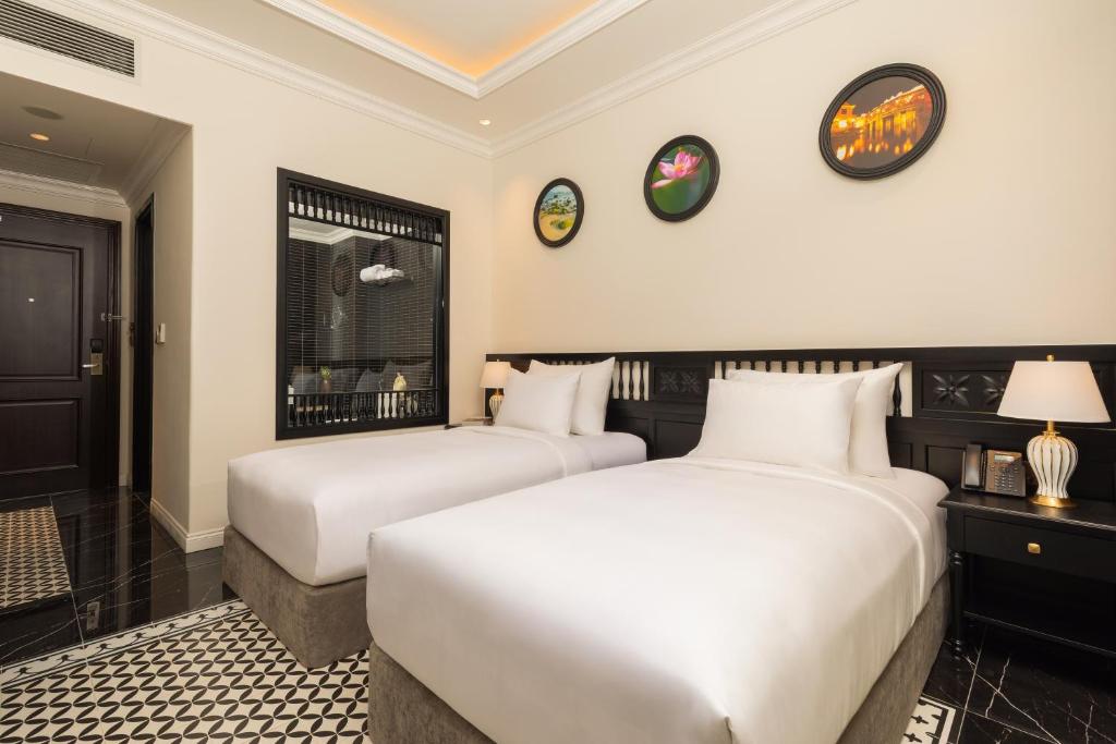 Postel nebo postele na pokoji v ubytování Nesta Hoian Resort & Spa