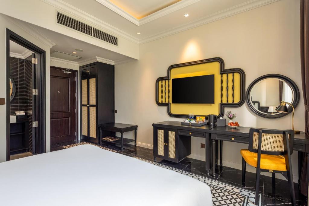 Giường trong phòng chung tại Nesta Hoian Resort & Spa