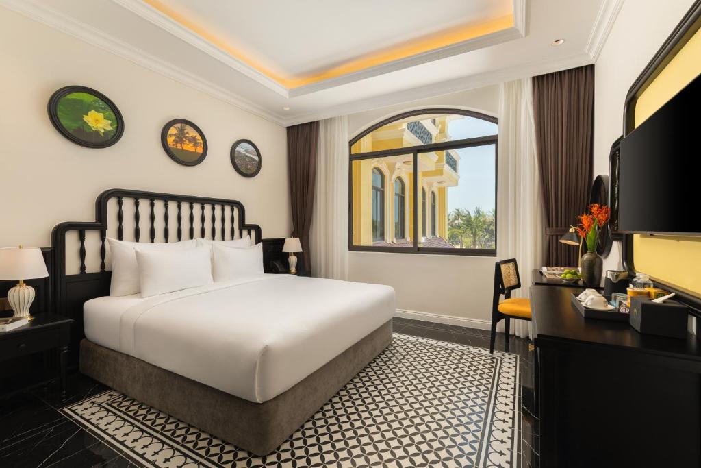 Giường trong phòng chung tại Nesta Hoian Resort & Spa