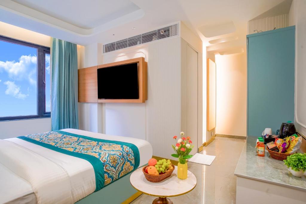 a hotel room with a bed and a television at Hotel Horizon By Shanti near New Delhi Railway Station in New Delhi