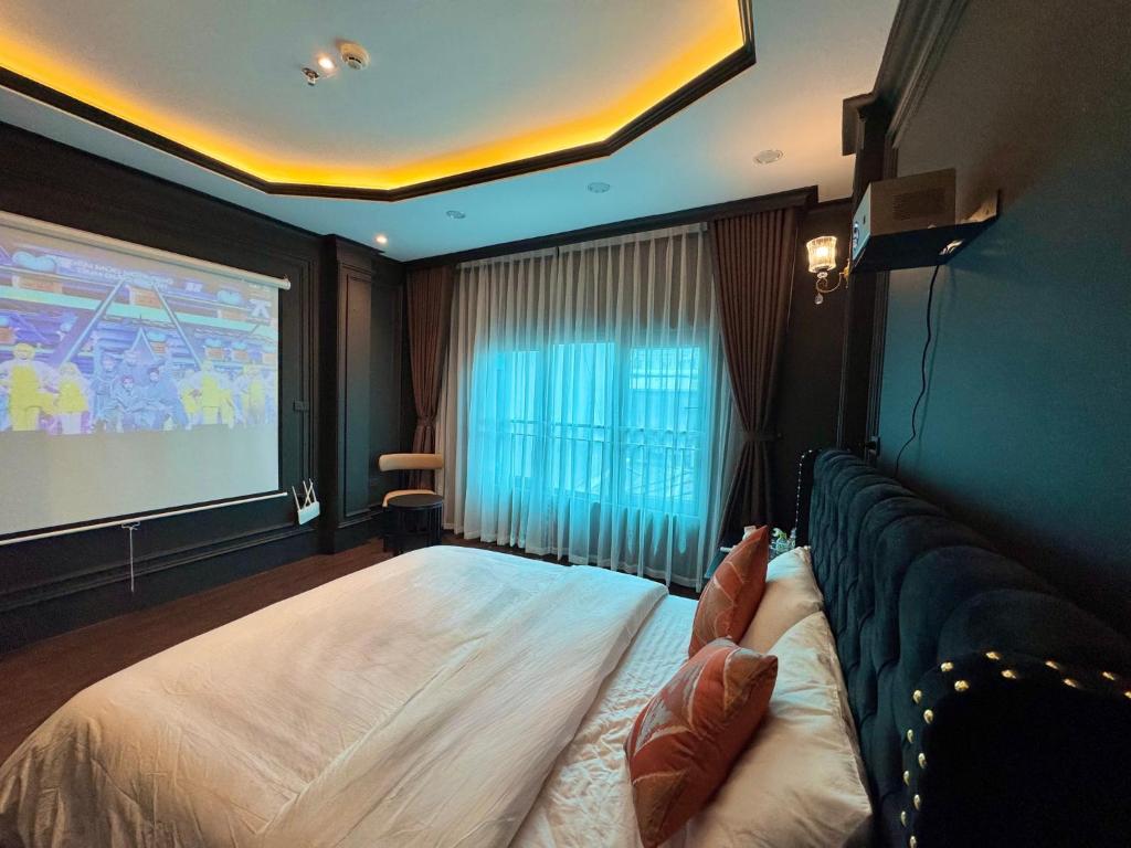 a hotel room with a bed and a projection screen at Star Night Hotel and Apartment in Hanoi