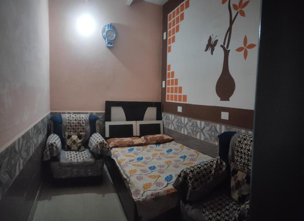 a living room with a couch and two chairs at Kanha Dham Dharamshala in Mathura