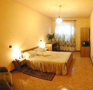 Postel nebo postele na pokoji v ubytování Hotel Sassacci
