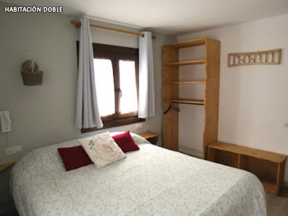 Postel nebo postele na pokoji v ubytování Hostal Rural Sant Climent