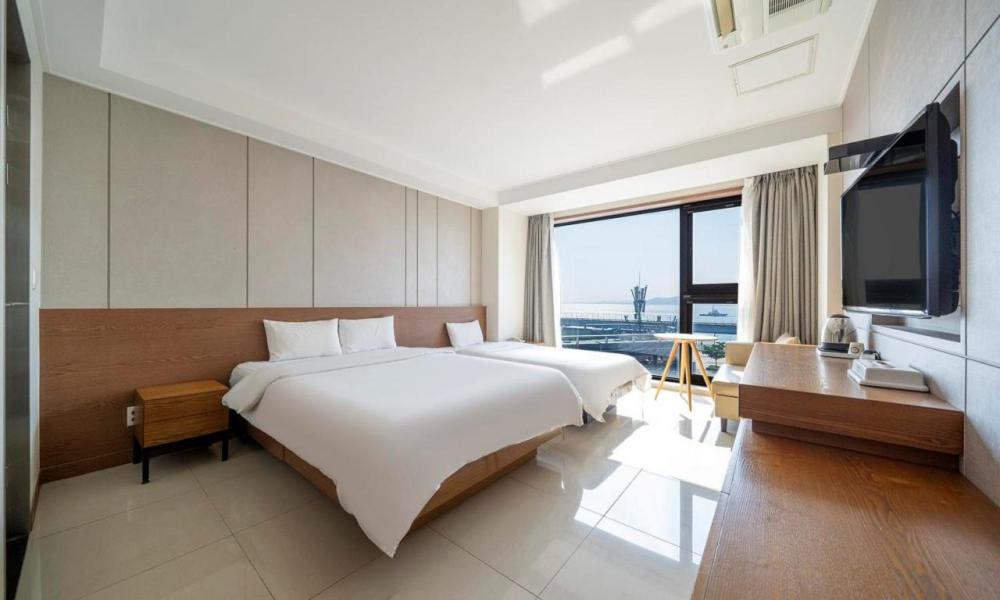 Postel nebo postele na pokoji v ubytování Wolmido Premiers Hotel
